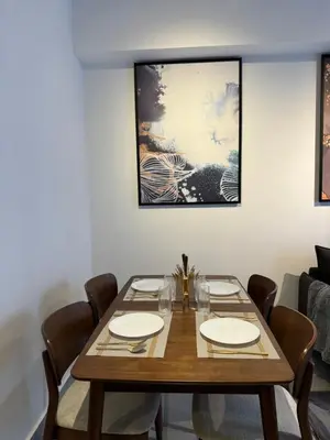 a dining room with a wooden table and chairs at AGILE Galaxy Suite in Kuala Lumpur