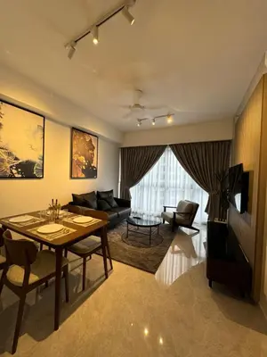 a living room with a table and a couch at AGILE Galaxy Suite in Kuala Lumpur