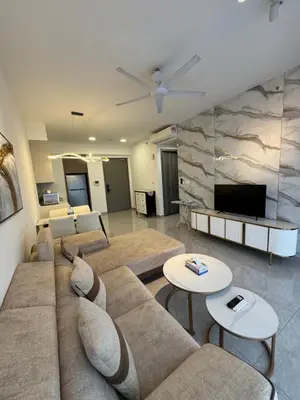 a living room with a couch and a flat screen tv at AGILE Galaxy Suite in Kuala Lumpur