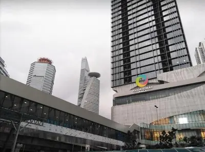 a large building in a city with tall buildings at KL Gateway Residence Bangsar by The Luxe in Kuala Lumpur