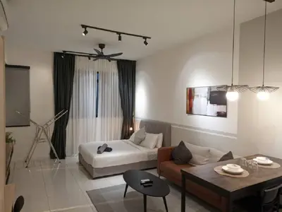 a living room with a bed and a couch at Starlight Suite At Chambers Kuala Lumpur KLCC in Kuala Lumpur