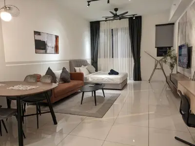 a living room with a couch and a table at Starlight Suite At Chambers Kuala Lumpur KLCC in Kuala Lumpur