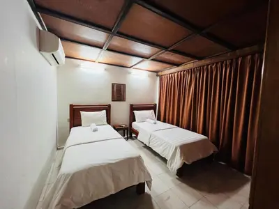 two beds sitting in a room with curtains at Iviillainn in Kuala Lumpur