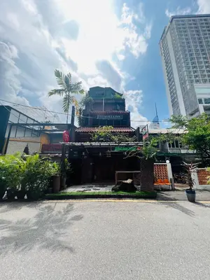 a building in the middle of a city with tall buildings at Iviillainn in Kuala Lumpur