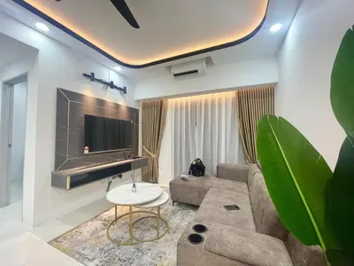 a living room with a couch and a tv at Homestay Inspirasi in Kuala Lumpur
