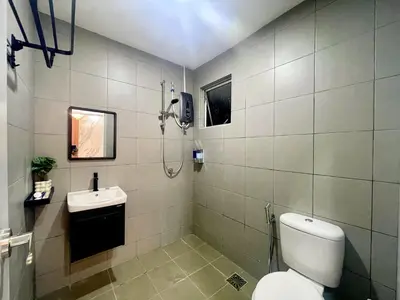 a bathroom with a toilet and a sink at Homestay Inspirasi in Kuala Lumpur