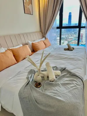 a bedroom with a large white bed with a window at 9 Pax 3R3B Trion KL City View 10Mins to KLCC in Kuala Lumpur