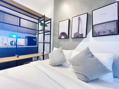 a bedroom with a white bed with a radio on the wall at The colony by Klcc view sweet home in Kuala Lumpur
