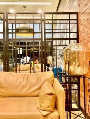 a living room with a couch and a table at Mini studio Neu suites KLCC in Kuala Lumpur