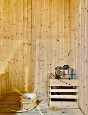 a room with a wooden wall with a table and a bucket at Mini studio Neu suites KLCC in Kuala Lumpur