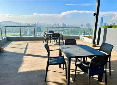 a patio with tables and chairs and a view of the city at Private Room Queen Size KLCC in Kuala Lumpur