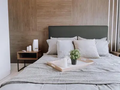 a bed with a tray with a plant on it at Cozy Kenwingston Platz KL 2-5 Pax 2BR & 2BR FrePakin Netflix 2802 in Kuala Lumpur