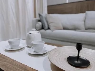 a coffee table with two cups and saucers on it at Cozy Kenwingston Platz KL 2-5 Pax 2BR & 2BR FrePakin Netflix 2802 in Kuala Lumpur