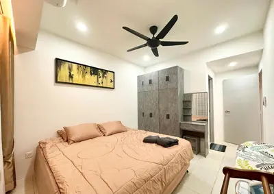 a bedroom with a bed and a ceiling fan at Homestay Inspirasi in Kuala Lumpur