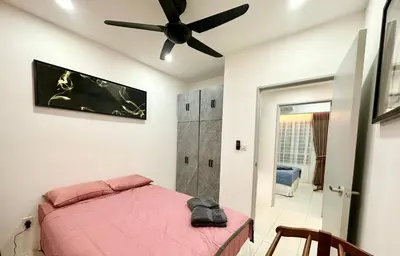 a bedroom with a pink bed and a ceiling fan at Homestay Inspirasi in Kuala Lumpur