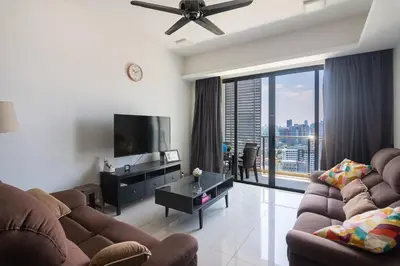 a living room with a couch and a flat screen tv at Chic High-Floor 3BR Apt in Bukit Bintang in Kuala Lumpur