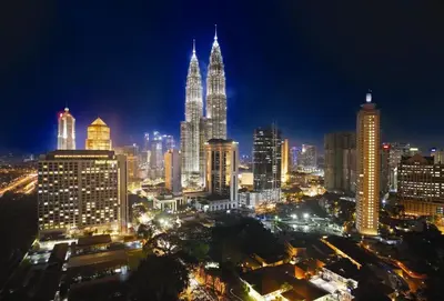 a night view of a city with tall buildings at Chic High-Floor 3BR Apt in Bukit Bintang in Kuala Lumpur