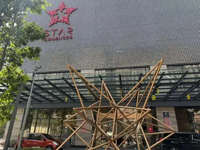a large metal sculpture in front of a building at Star Deluxe Suites KLCC by WSD in Kuala Lumpur