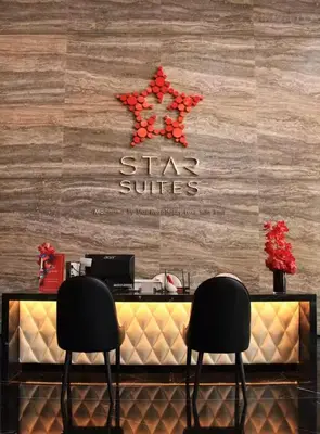 two chairs sitting in front of a star services counter at Star Deluxe Suites KLCC by WSD in Kuala Lumpur