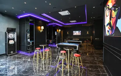 a poker room with stools and a ping pong table at Star Deluxe Suites KLCC by WSD in Kuala Lumpur