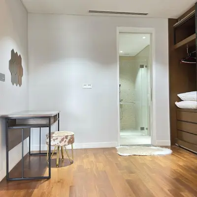 a bedroom with a desk and a glass shower stall at XING LUN KLCC Anggun residents in Kuala Lumpur