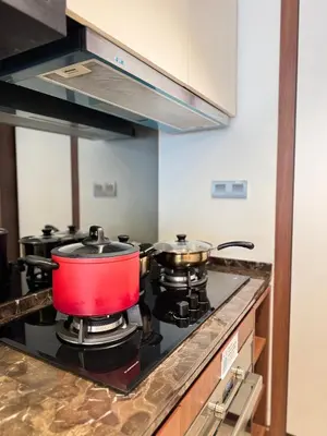 a red pot on a stove in a kitchen at XING LUN KLCC Anggun residents in Kuala Lumpur