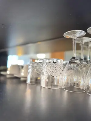a row of wine glasses sitting on a counter at XING LUN KLCC Anggun residents in Kuala Lumpur