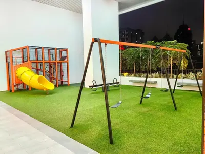 a play area with swings and grass at Chamber Resident Service KLCC in Kuala Lumpur