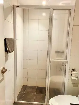 a bathroom with a shower and a toilet at Chamber Resident Service KLCC in Kuala Lumpur