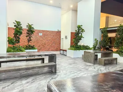a lobby with benches and plants in a building at Chamber Resident Service KLCC in Kuala Lumpur