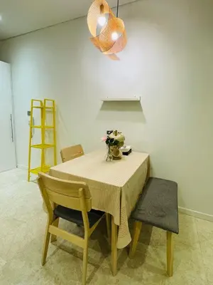a dining room table with two chairs and a light fixture at URBAN COZY HOME at SkySuites Near KLCC Complimentary Breakfast in Kuala Lumpur