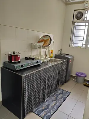 a kitchen with a counter with a sink and a stove at One Bedroom Apartment at Kuala Lumpur in Kuala Lumpur
