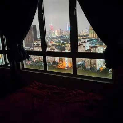 a room with a window with a view of a city at One Bedroom Apartment at Kuala Lumpur in Kuala Lumpur