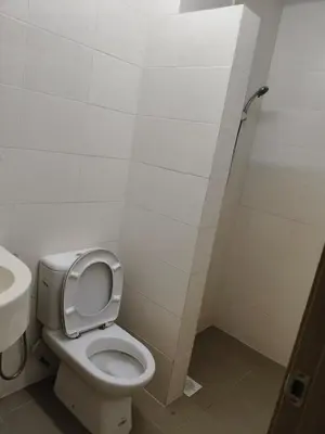 a bathroom with a toilet and a sink at One Bedroom Apartment at Kuala Lumpur in Kuala Lumpur