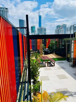 a balcony with a colorful fence and a bench at EASSY Hotel KL Sentral in Kuala Lumpur