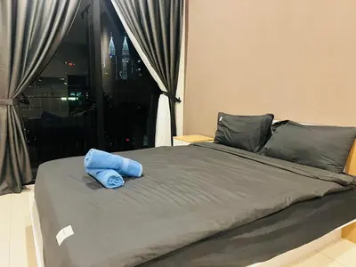 a bed with a blue towel on top of it at Chamber KL Residence by Moon Orchid in Kuala Lumpur