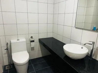 a bathroom with a white toilet and a sink at Chamber KL Residence by Moon Orchid in Kuala Lumpur