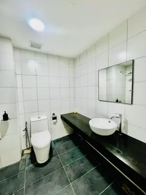 a bathroom with a toilet and a sink at Chamber KL Residence by Moon Orchid in Kuala Lumpur