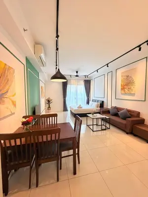 a living room with a table and a couch at Chamber KL Residence by Moon Orchid in Kuala Lumpur