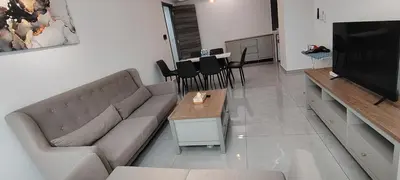 a living room with a couch and a television at KLCC Agile Residences By Bukit Bentang Pevilion With Trx in Kuala Lumpur