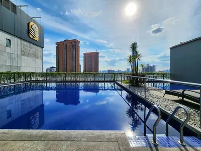 a swimming pool with a city skyline in the background at Bukit Bintang Fairlane Residence Kuala Lumpur #1510 in Kuala Lumpur