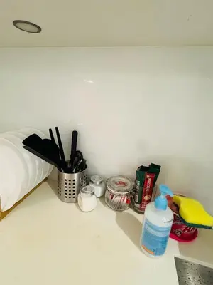 a counter top with a bottle of water and other items at URBAN COMFY HOME at SkySuites Near KLCC Complimentary Breakfast in Kuala Lumpur