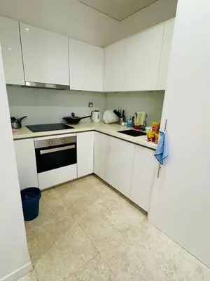 a kitchen with white cabinets and a stove top oven at URBAN COMFY HOME at SkySuites Near KLCC Complimentary Breakfast in Kuala Lumpur