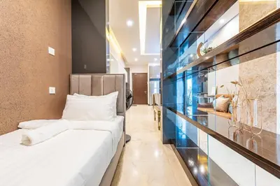 a bedroom with a bed and a wall of glass at Dorsett Residence Kuala Lumpur #21 in Kuala Lumpur
