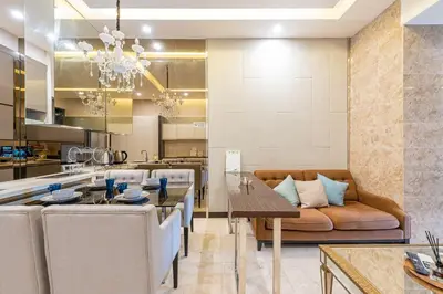 a kitchen and living room with a table and a couch at Dorsett Residence Kuala Lumpur #21 in Kuala Lumpur
