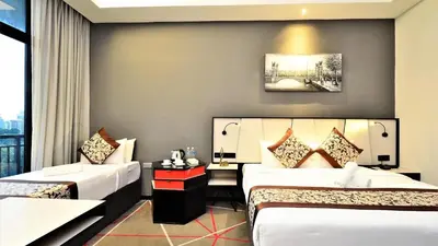 a hotel room with two beds and a window at Red M101 Dang Wangi By Oak Tree in Kuala Lumpur