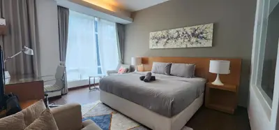 a bedroom with a large bed and a window at COZY SUPER KING BED STUDIO walking to PETRONAS KLCC by Zen Glo in Kuala Lumpur