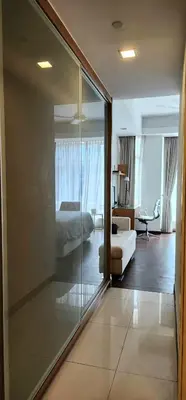 a hotel room with a bed and a glass wall at COZY SUPER KING BED STUDIO walking to PETRONAS KLCC by Zen Glo in Kuala Lumpur