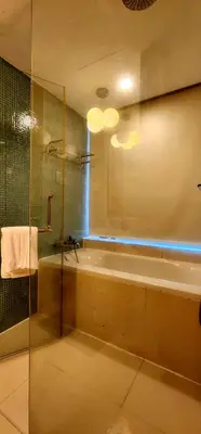 a bathroom with a bath tub and a shower at COZY SUPER KING BED STUDIO walking to PETRONAS KLCC by Zen Glo in Kuala Lumpur