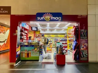a man is standing in a store in a supermarket at LATEST facing Pavilion main entrance in Kuala Lumpur